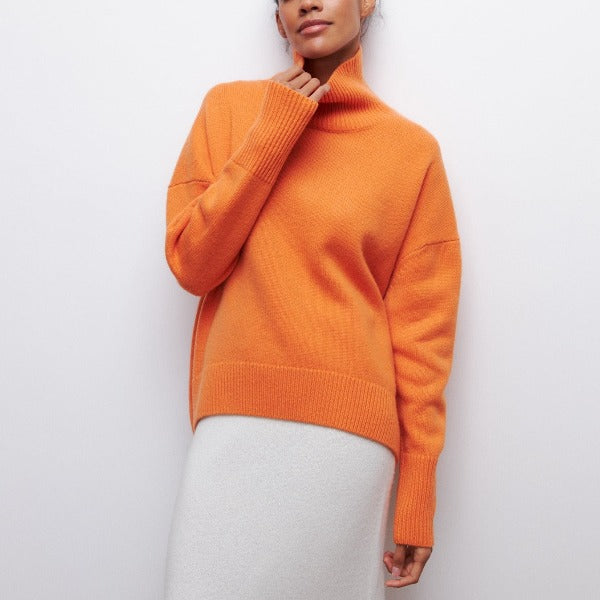 Ava Mae Avery high neck pullover in a cozy knit, featuring a fitted silhouette and ribbed collar, shown in a neutral color.