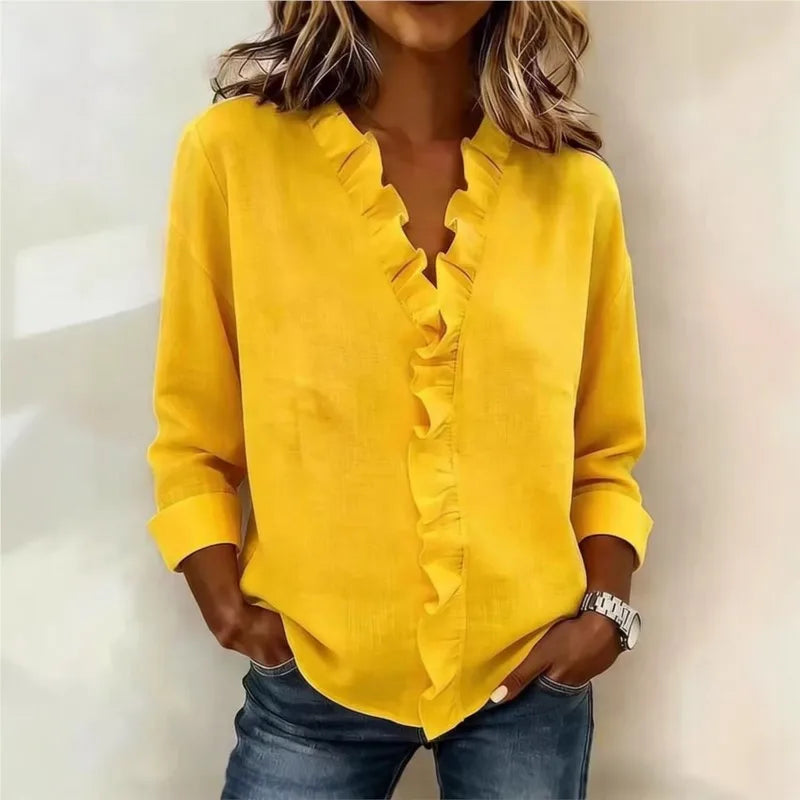 Veda Bremen Sorelle™ blouse featuring vertical ruffle detail and timeless style, shown in a close-up of the elegant fabric and design.