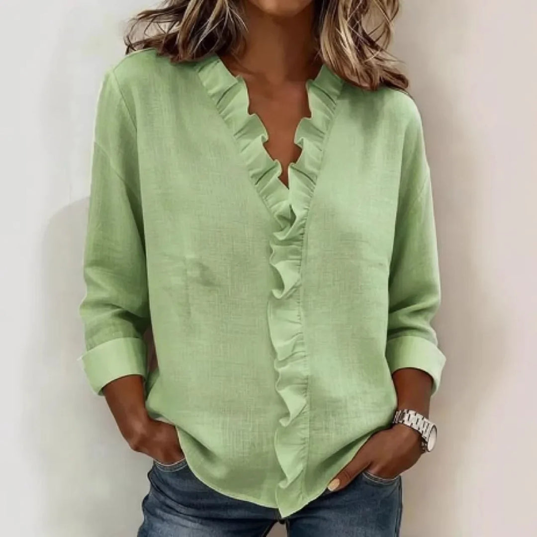 Veda Bremen Sorelle™ blouse with vertical ruffle, lightweight fabric, and timeless style, shown in a close-up of the ruffled front detail.