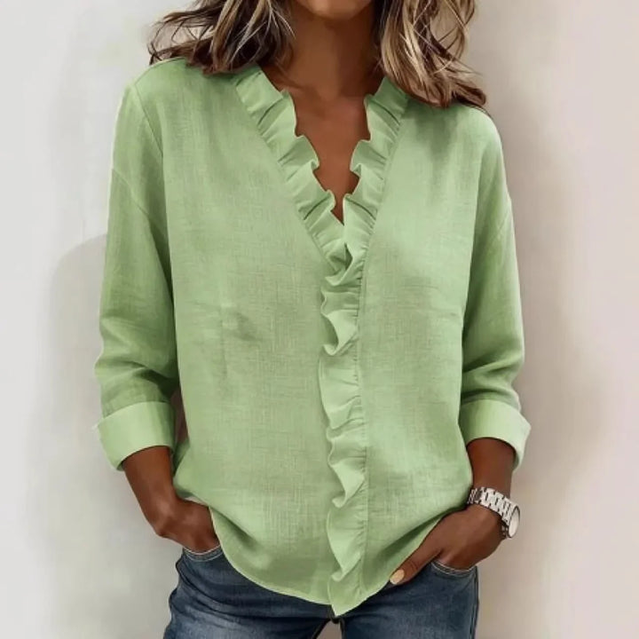 Veda Bremen Sorelle™ blouse with vertical ruffle, lightweight fabric, and timeless style, shown in a close-up of the ruffled front detail.