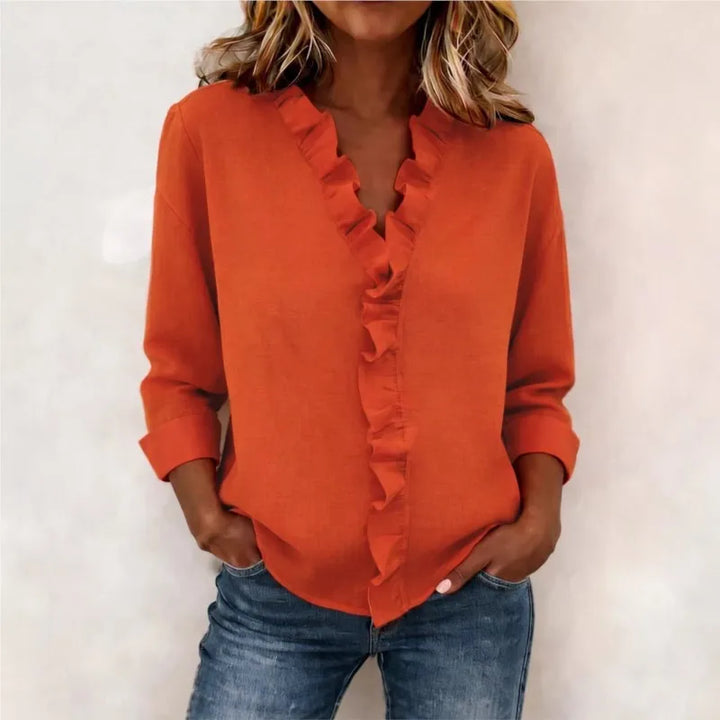 Veda Bremen Sorelle™ blouse with vertical ruffle, showcasing elegant, timeless style and lightweight fabric in soft tones.