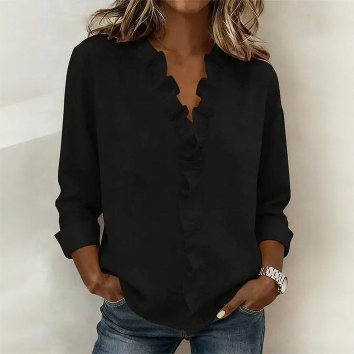 Veda Bremen Sorelle™ blouse with vertical ruffle detail, featuring a timeless, elegant style in soft fabric.