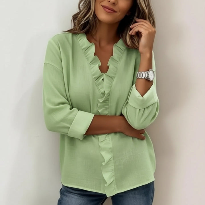 Veda Bremen Sorelle blouse with vertical ruffle details, showcasing timeless style and elegant design on a white fabric background.