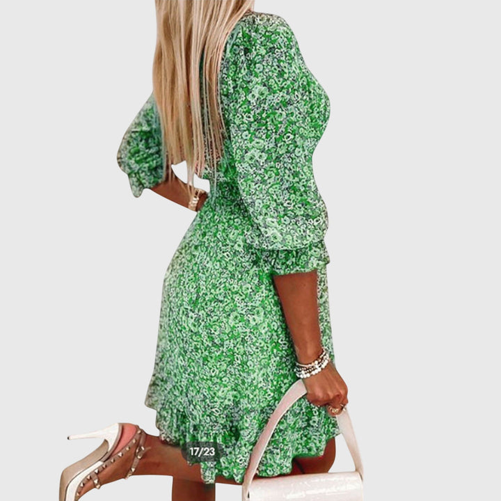 Veda Bremen Elisa floral puff-sleeve dress with ruffled neckline and vibrant flower pattern on lightweight fabric.