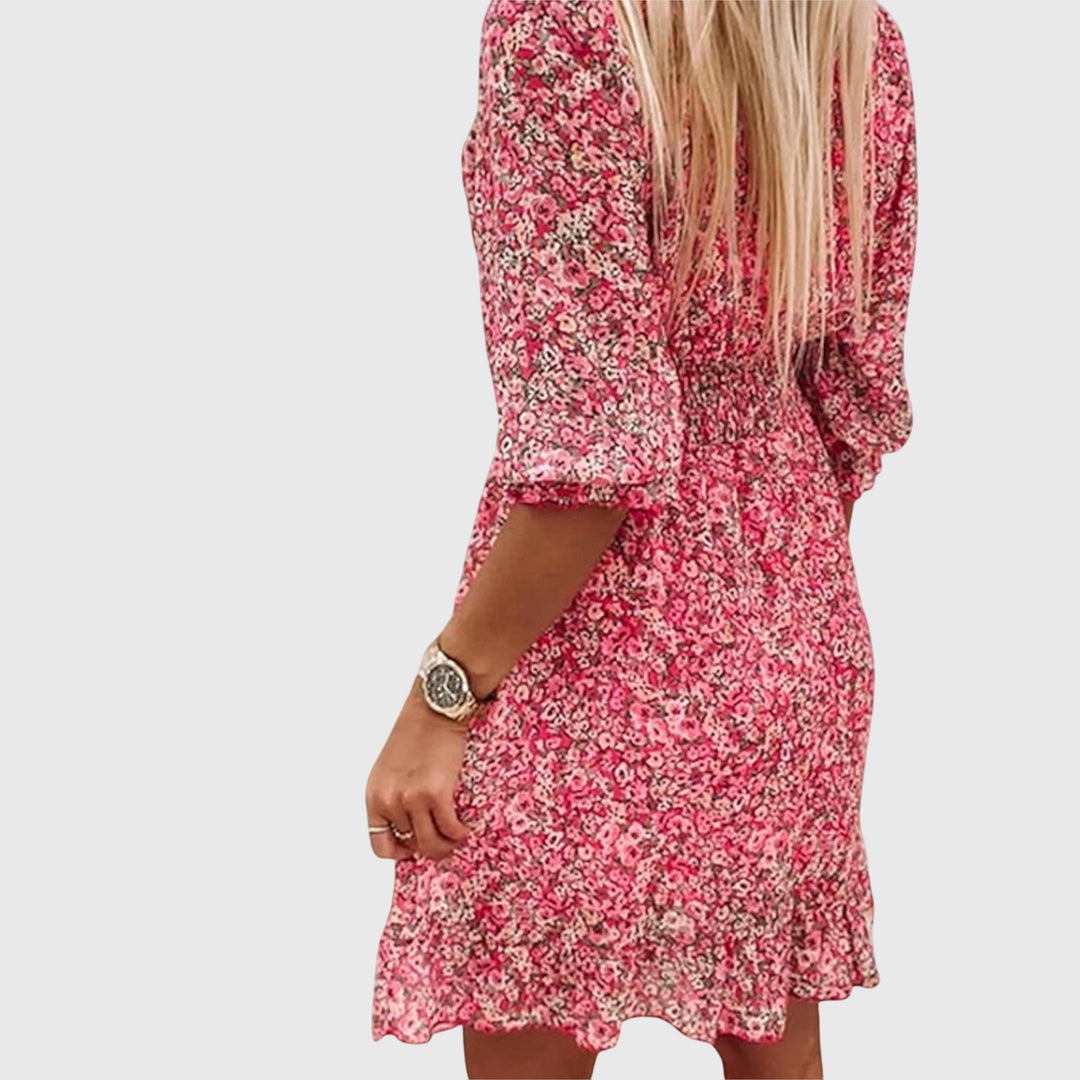 Veda Bremen Elisa floral puff-sleeve dress displayed on a hanger, featuring a feminine design with colorful floral patterns.