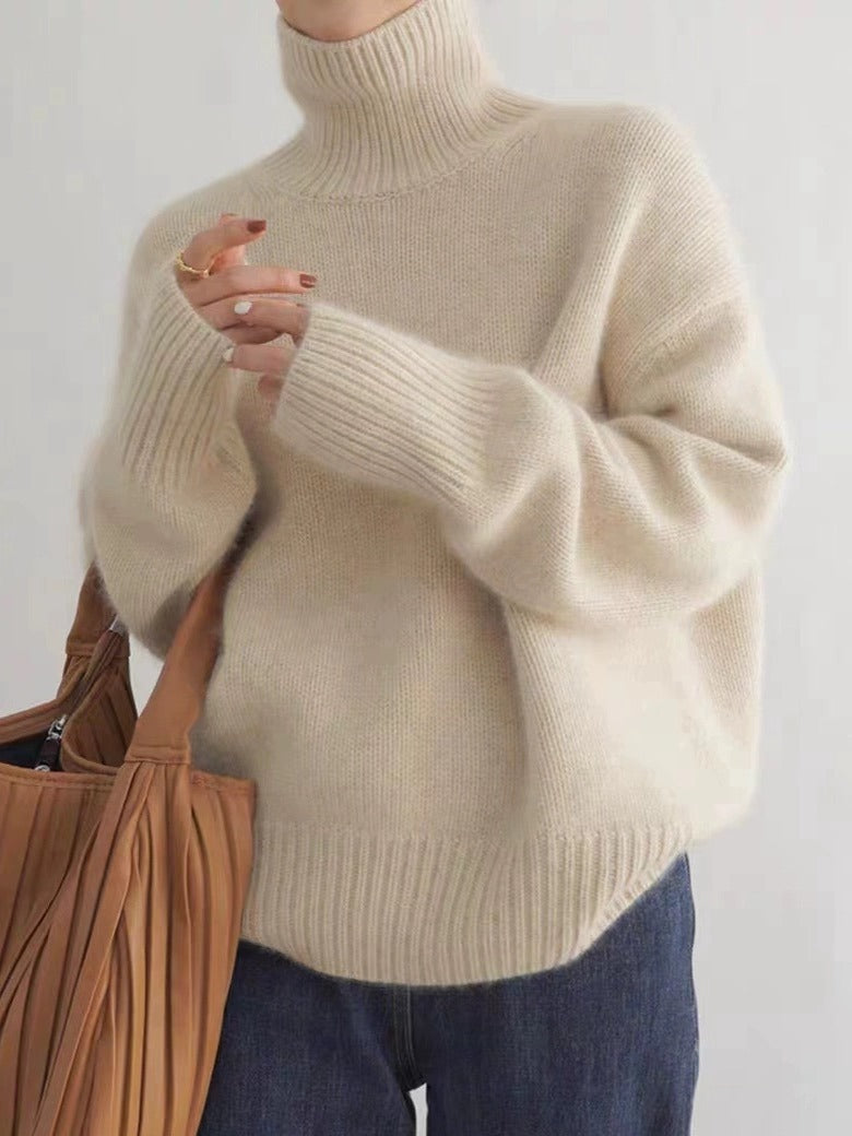 Apricot LuroLondon Marilou Cashmere Turtleneck sweater with a cozy fit and ribbed collar, showcased on a neutral background.