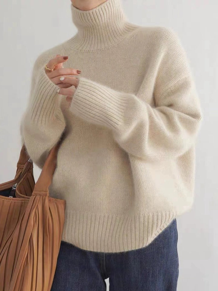 Apricot LuroLondon Marilou Cashmere Turtleneck sweater with a cozy fit and ribbed collar, showcased on a neutral background.
