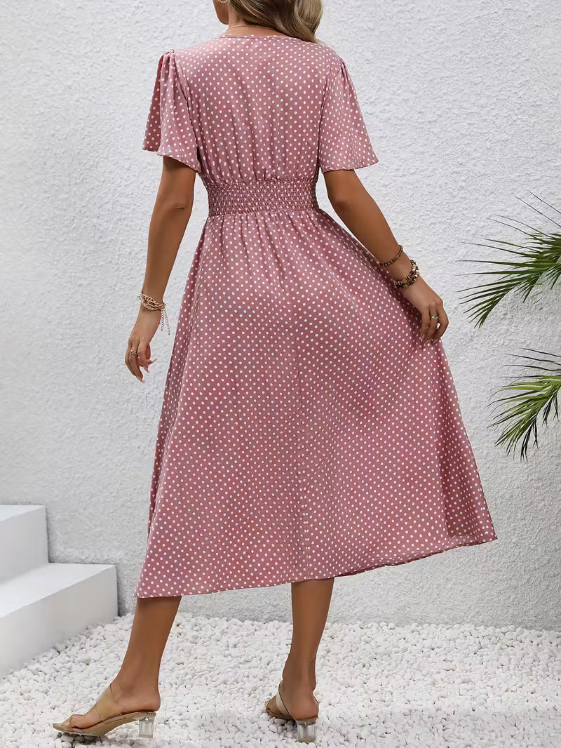 Back view of Veda Bremen's dotted dress featuring a flowing silhouette and stylish design in soft fabric.