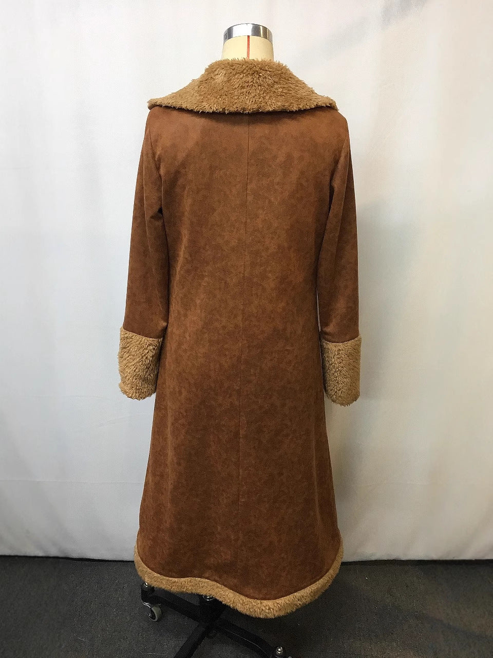 Back view of a vintage faux coat by Lurolondon.co.uk, showcasing classic design and textured fabric in a natural pose.