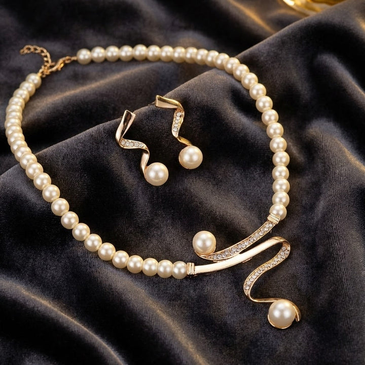 Elegant wave pearl jewelry set by Veda Bremen featuring matching earrings and a necklace with pearl accents.