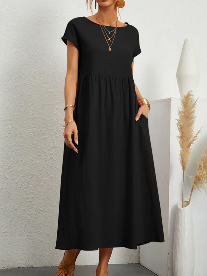 Veda Bremen Gabrielle mid-length dress with flowing black fabric and elegant silhouette.