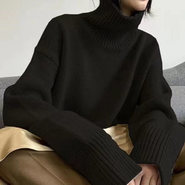 Black Marilou Cashmere Turtleneck sweater by LuroLondon, showcasing a cozy, stylish knit with a high turtleneck and ribbed cuffs.