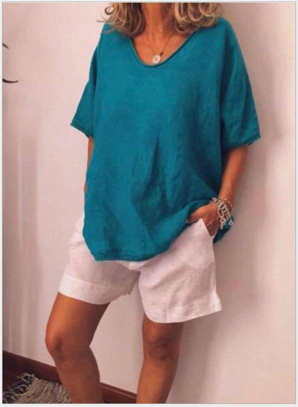 Blue Vivian versatile linen blouse by Veda Bremen, shown on a hanger with detailed fabric texture and relaxed fit.
