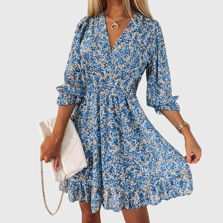 Veda Bremen Elisa floral puff-sleeve dress in lightweight fabric with a fitted waist and playful puffed sleeves.