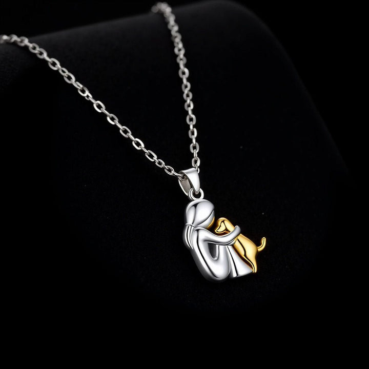 Veda Bremen dog-shaped pendant necklace with matching earrings, featuring a faithful dog design, on a plain background.