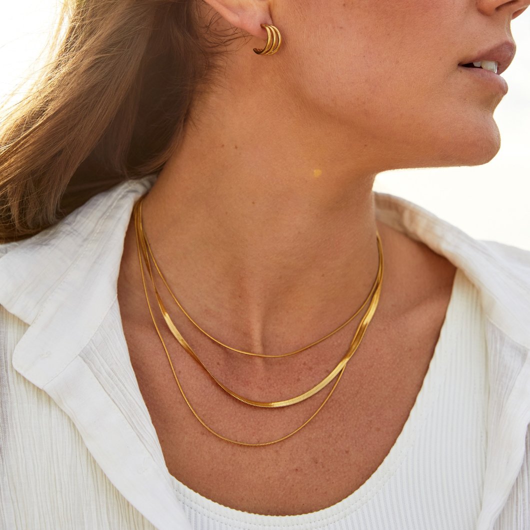 Multi-layered gold chain necklace by Veda Bremen featuring intricate links and a stylish layered design.