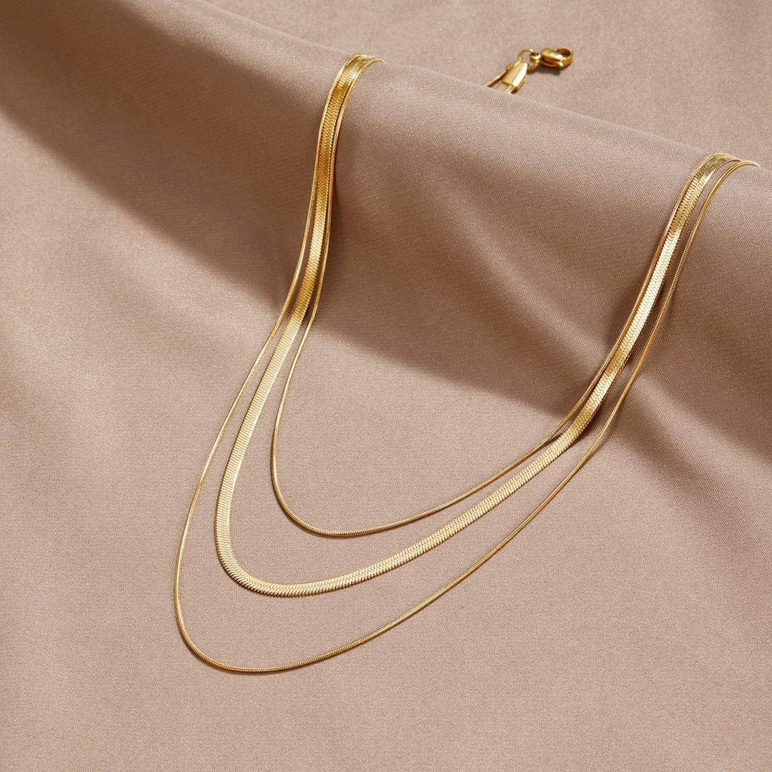 Multi-layered gold necklace by Veda Bremen featuring layered chains and intricate gold details.
