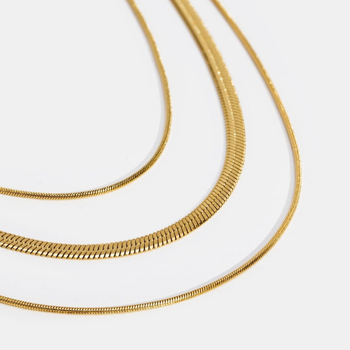 Veda Bremen multi-layered gold chain necklace with delicate overlapping links on a white background.