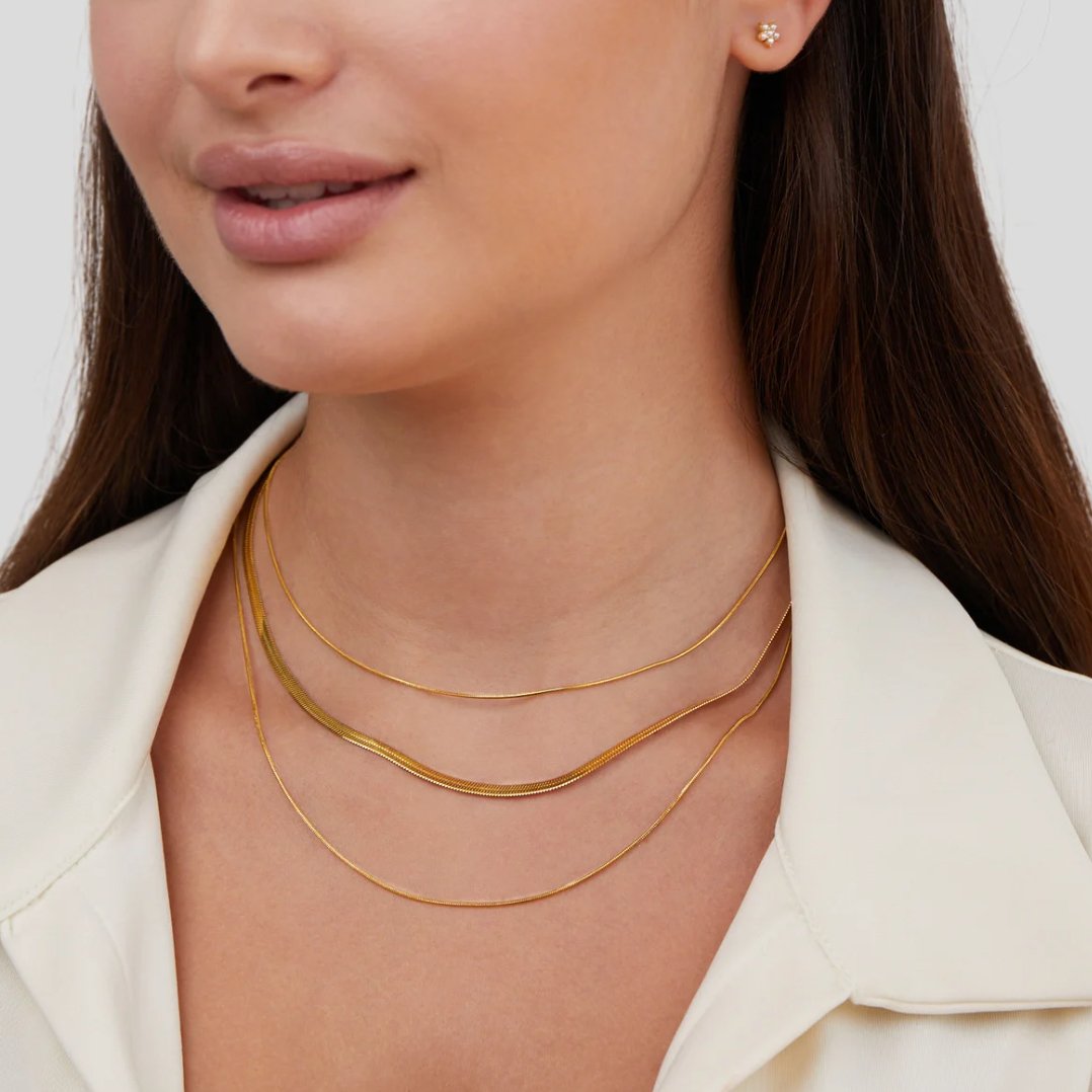 Multi-layered gold necklace by Veda Bremen featuring delicate chains and a stylish layered design.