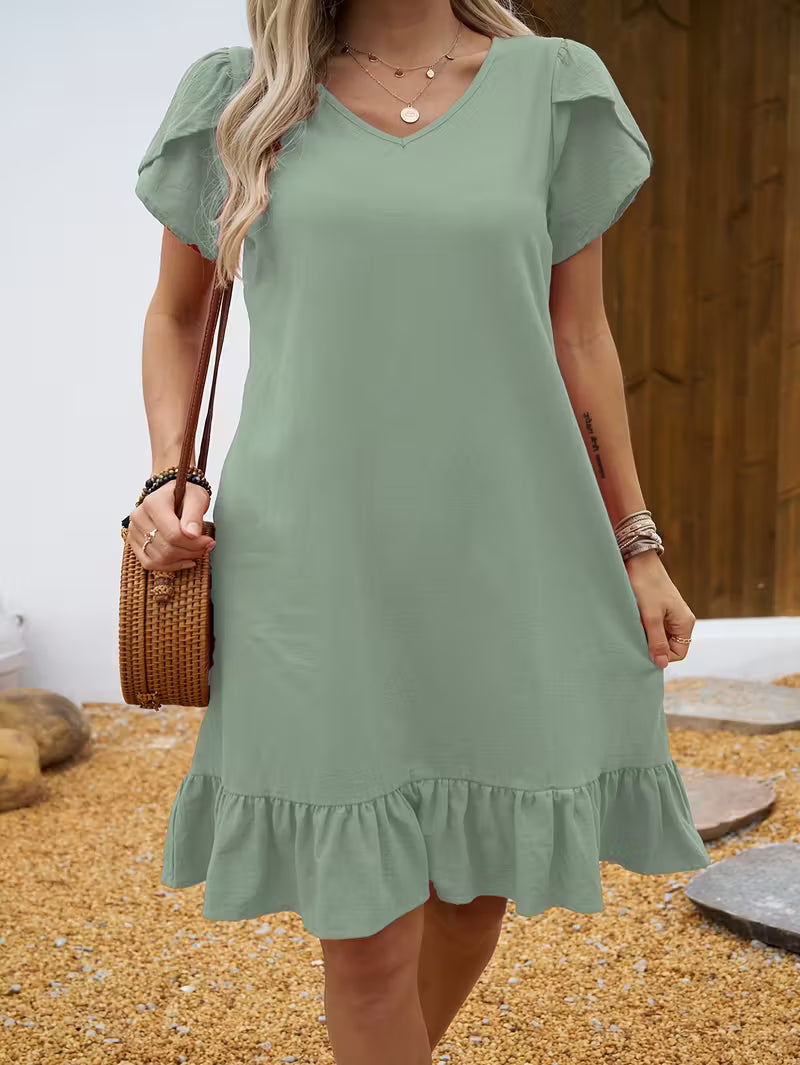 Green Veda Bremen V-neck dress with a stylish V-neckline, made from soft, flowing fabric perfect for casual or semi-formal wear.