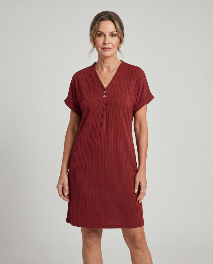 LuroLondon V-neck short sleeve dress featuring a fitted silhouette and elegant design, shown in a stylish outdoor setting.