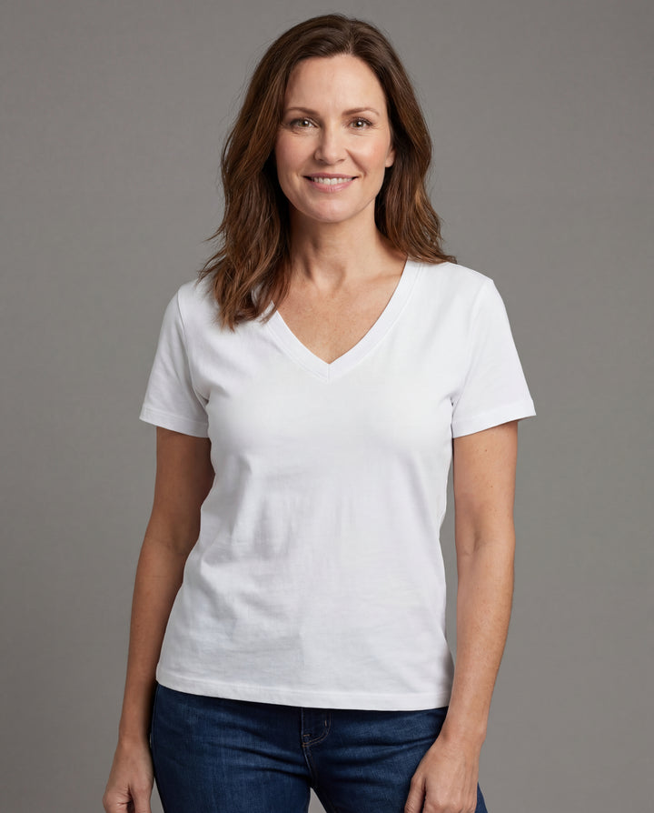 Woman wearing a plain white t-shirt against a gray background