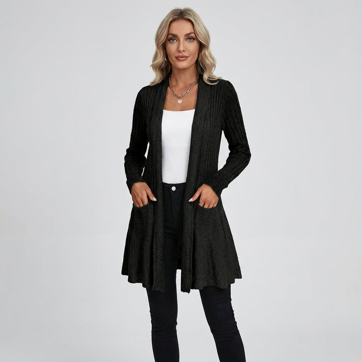Veda Bremen structured knit cardigan with textured pattern, long sleeves, and button closure, displayed on a hanger.