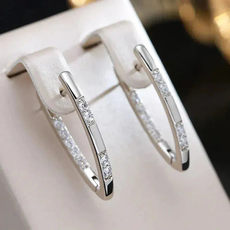 Veda Bremen elegant earrings with sparkling zirconia stones, showcasing intricate design and shiny gemstone accents.