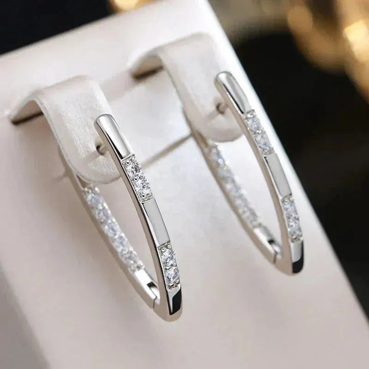 Veda Bremen elegant earrings with sparkling zirconia stones, showcasing intricate design and shiny gemstone accents.