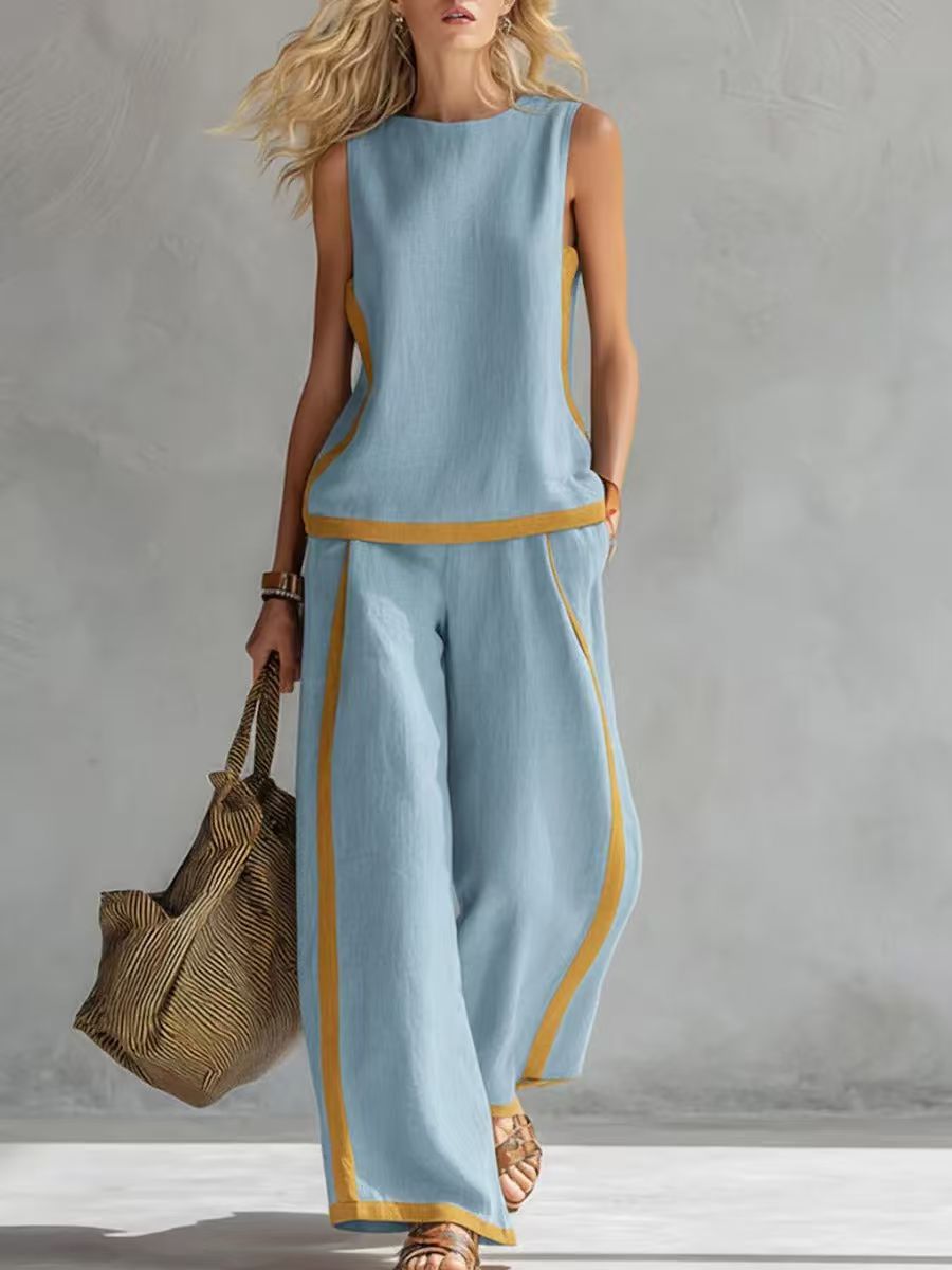 Light blue Cassie linen set by Veda Bremen, includes neatly folded bed sheets and pillowcases with soft fabric texture.