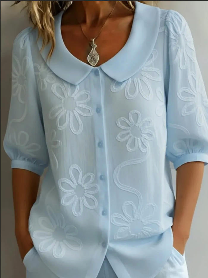 Light blue Veda Bremen Aggie lightweight floral blouse with delicate flower patterns and relaxed fit.