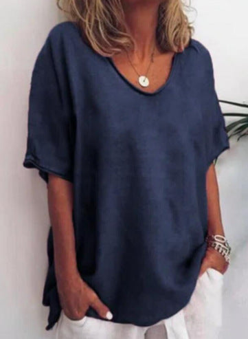 Navy blue Vivian versatile linen blouse by Veda Bremen displayed on a hanger, showcasing its relaxed fit and lightweight fabric.