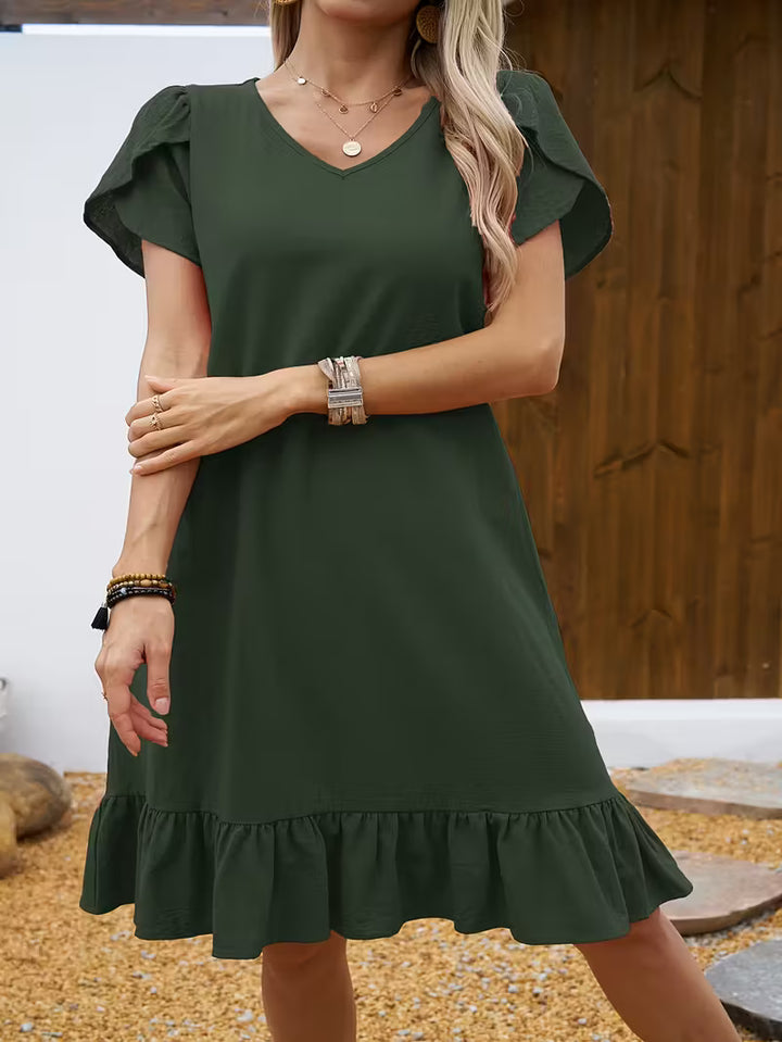 Olive Veda Bremen V-neck dress with short sleeves and a relaxed fit, perfect for casual or semi-formal occasions.