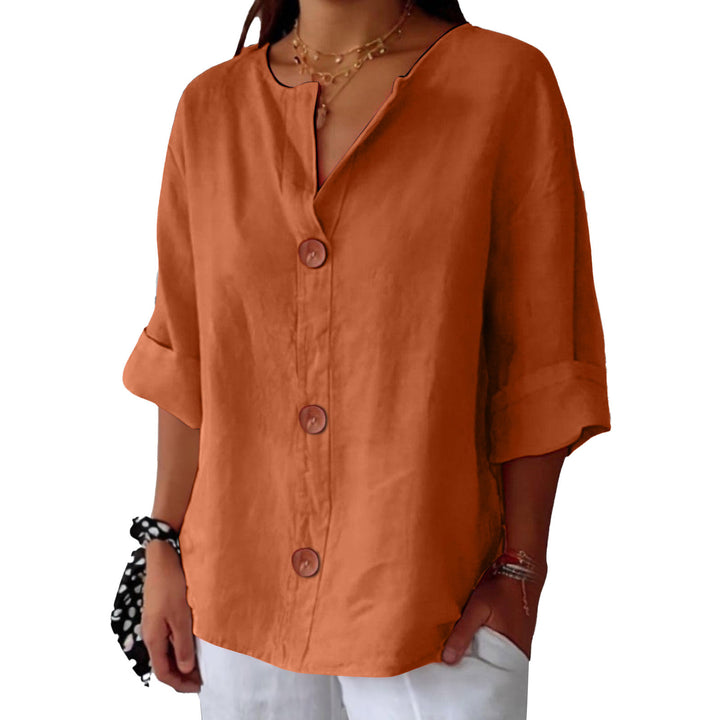 Orange Leah minimalist blouse by Veda Bremen, featuring a relaxed fit and simple design, displayed on a hanger.