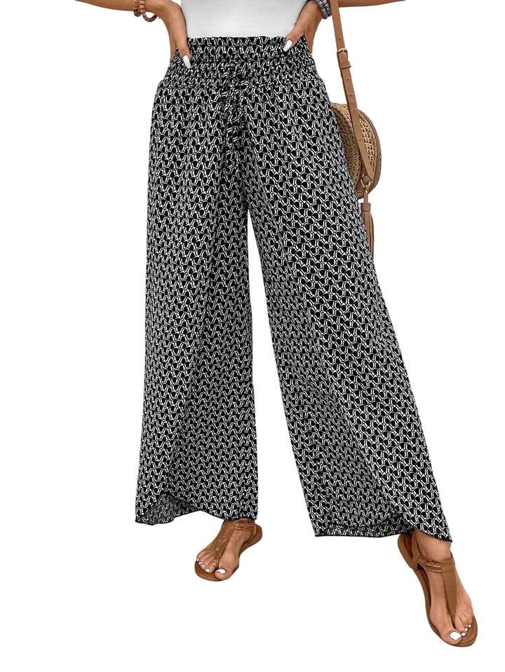 Veda Bremen Stella wide-leg printed pants in black, featuring a relaxed fit and bold print design.