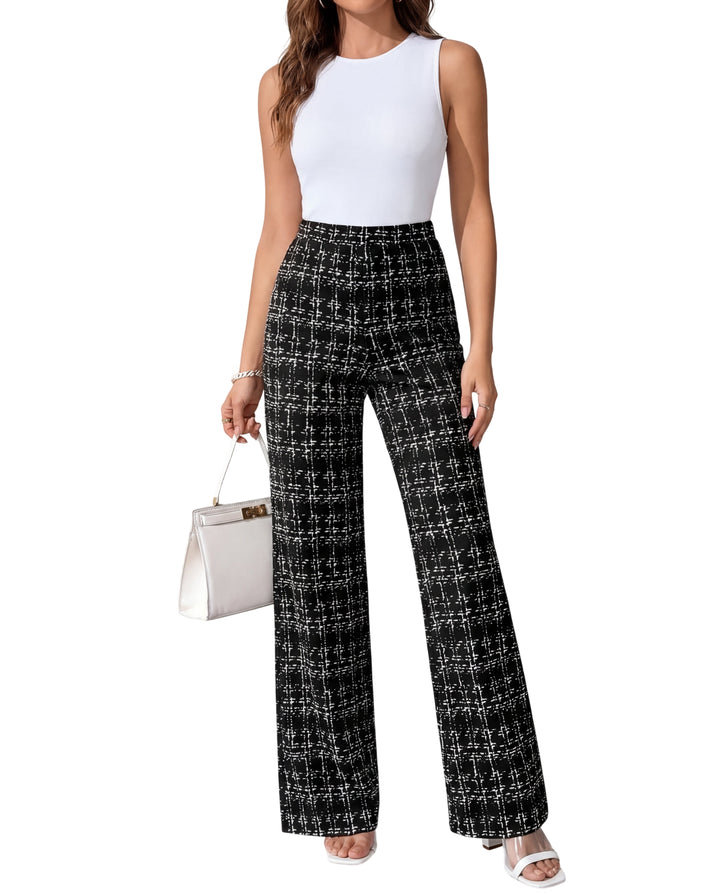 Woman wearing black and white patterned pants with a white top on a light gray background