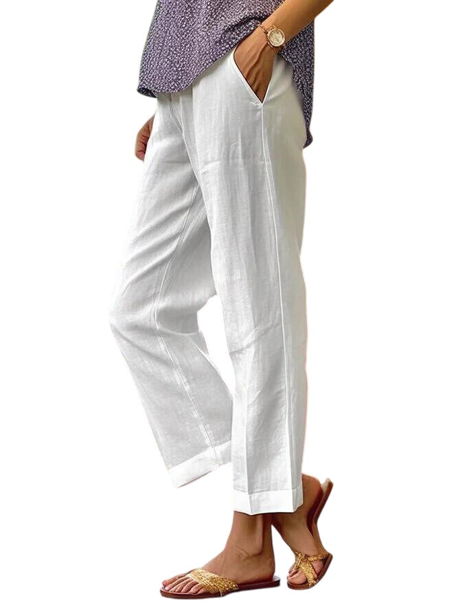 White Lisa lightweight trousers by LuroLondon displayed on a model, featuring a relaxed fit and casual style.