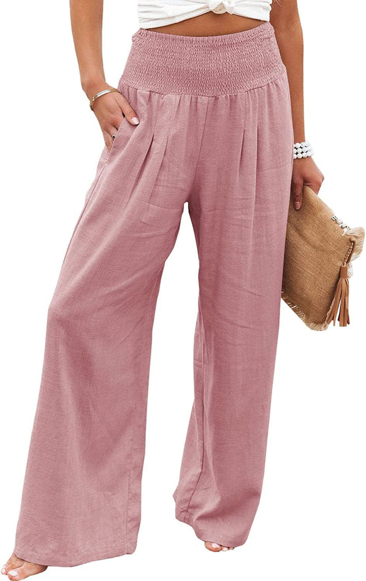 Pink Romy Weithose by Veda Bremen, stylish high-waisted wide-leg pants displayed on a model in a natural setting.