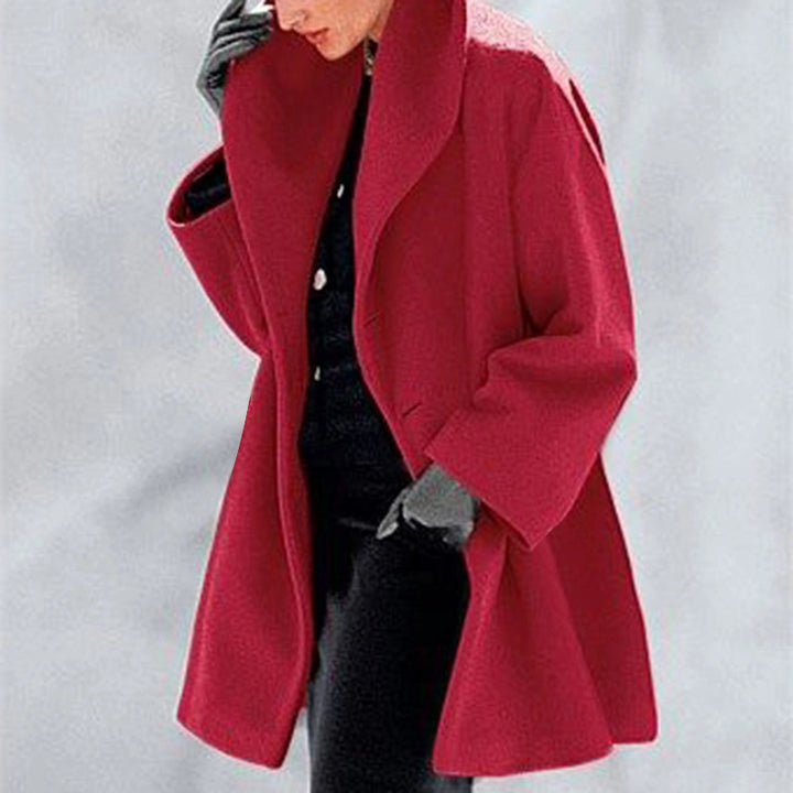 Red Cocoon Winter Coat by Lurolondon.co.uk, showcasing its cozy, oversized design with a high collar and button details.