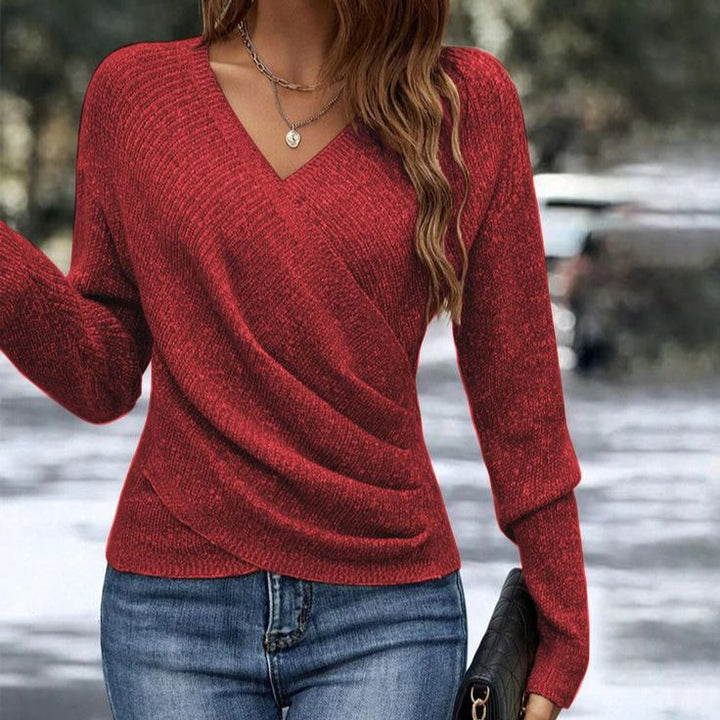 Red Vee-Neck Wrap Top by Lurolondon, featuring a stylish wrap design and fitted silhouette, displayed on a hanger.