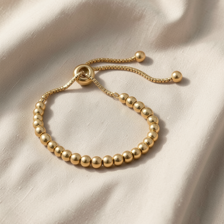 Veda Bremen gold beaded bracelet with intricate pearl detailing, elegant jewelry accessory on a neutral background.