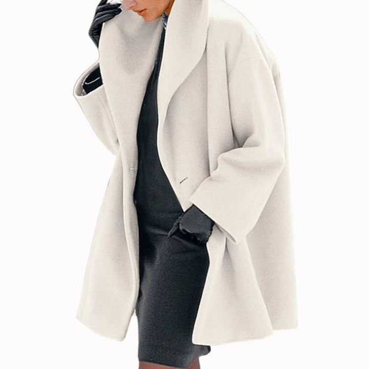 White Cocoon Winter Coat by Lurolondon.co.uk, featuring a cozy, insulated design with a high collar and sleek silhouette.