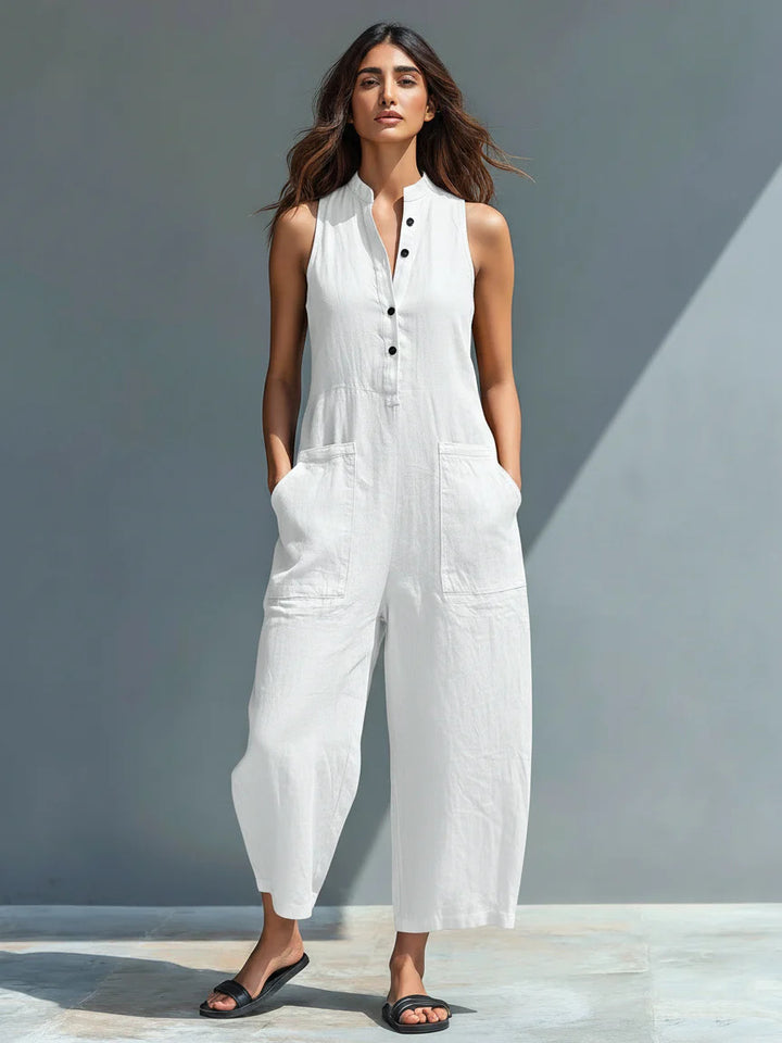 White Veda Bremen Lotte sleeveless minimalist jumpsuit displayed on a mannequin. Simple, elegant design with clean lines.