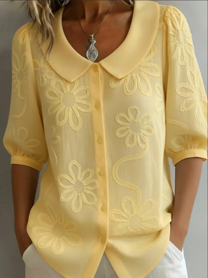 Veda Bremen Aggie lightweight yellow floral blouse with long sleeves and relaxed fit, displayed on a hanger.