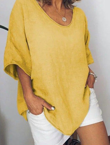 Yellow Veda Bremen Vivian versatile linen blouse with long sleeves and a relaxed fit, displayed on a hanger.